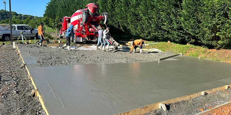 the santos hardscape & tree service team laying down fresh concrete for a new floor<br />
